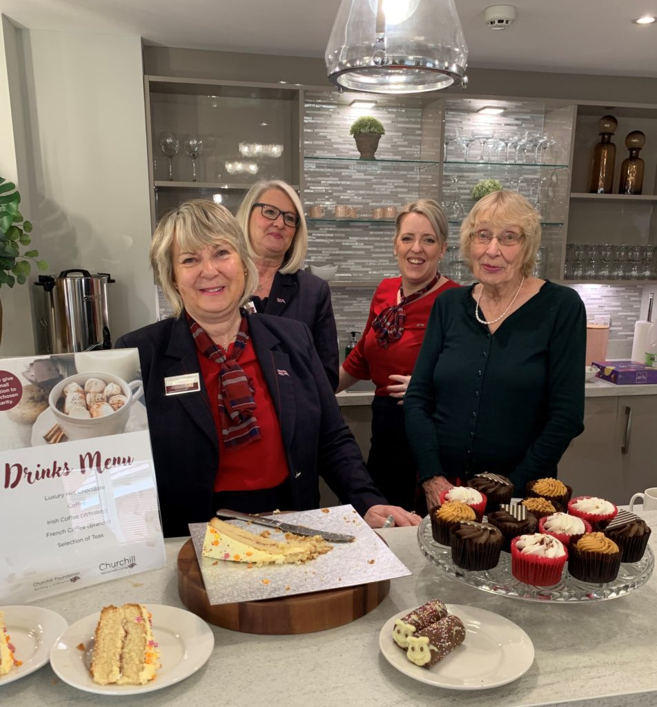 Staff and residents enjoy a celebration with cake.