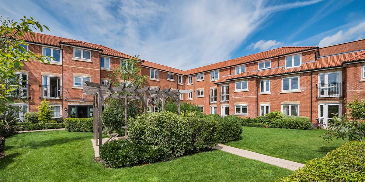 Well-maintained courtyard with greenery and residential buildings.