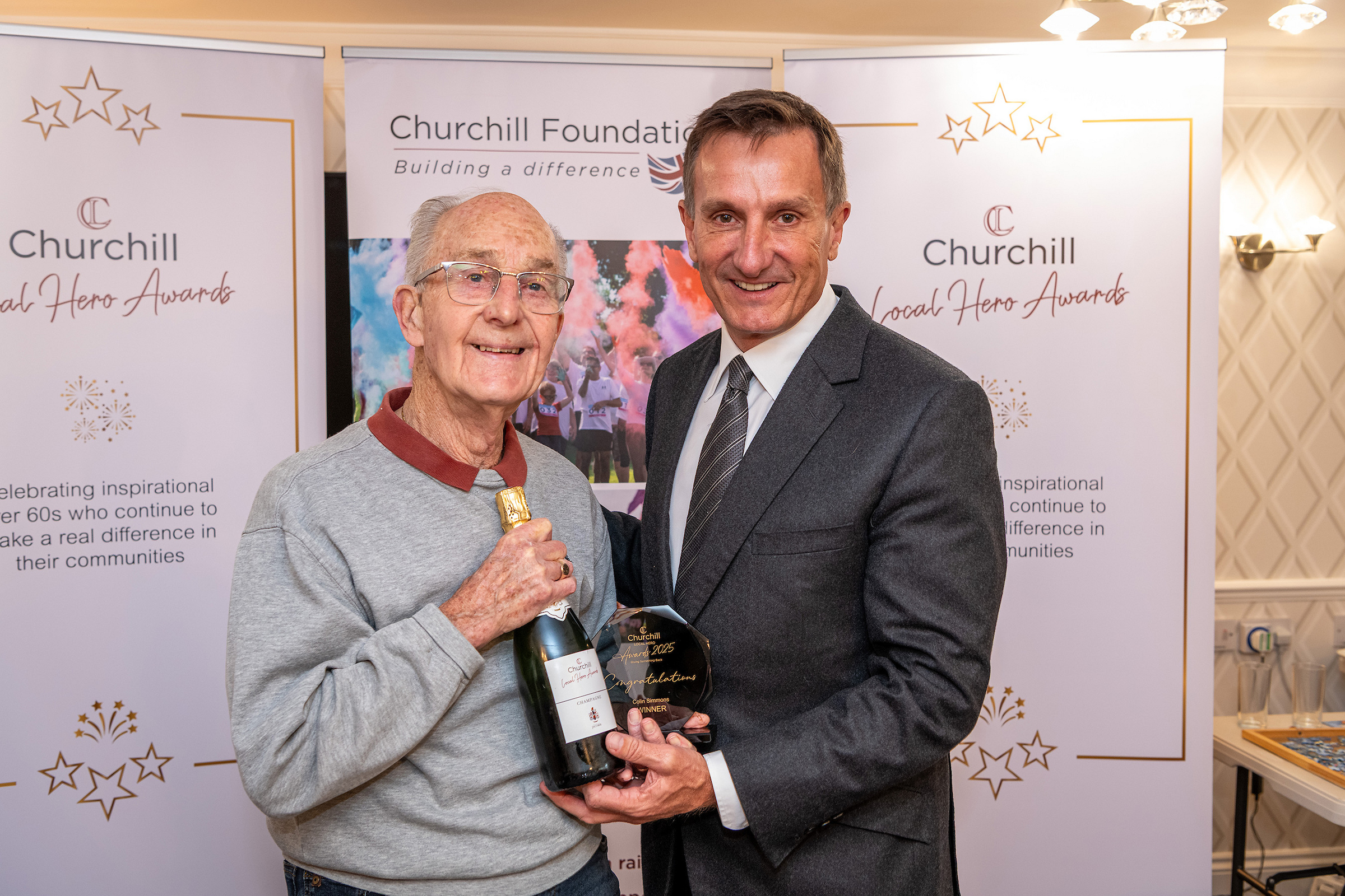 Resident receiving an award with staff member