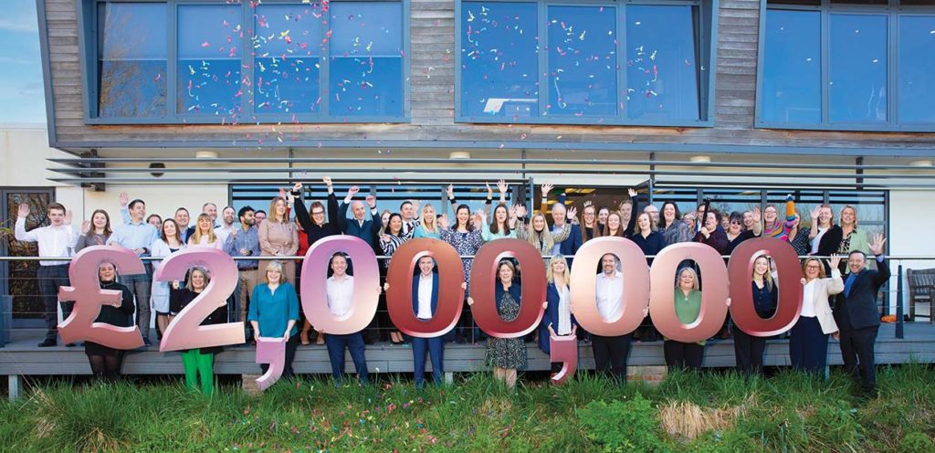 Celebration of fundraising success with staff and confetti.