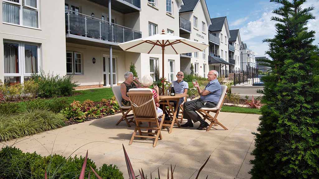 Residents enjoying time outdoors in a courtyard setting.