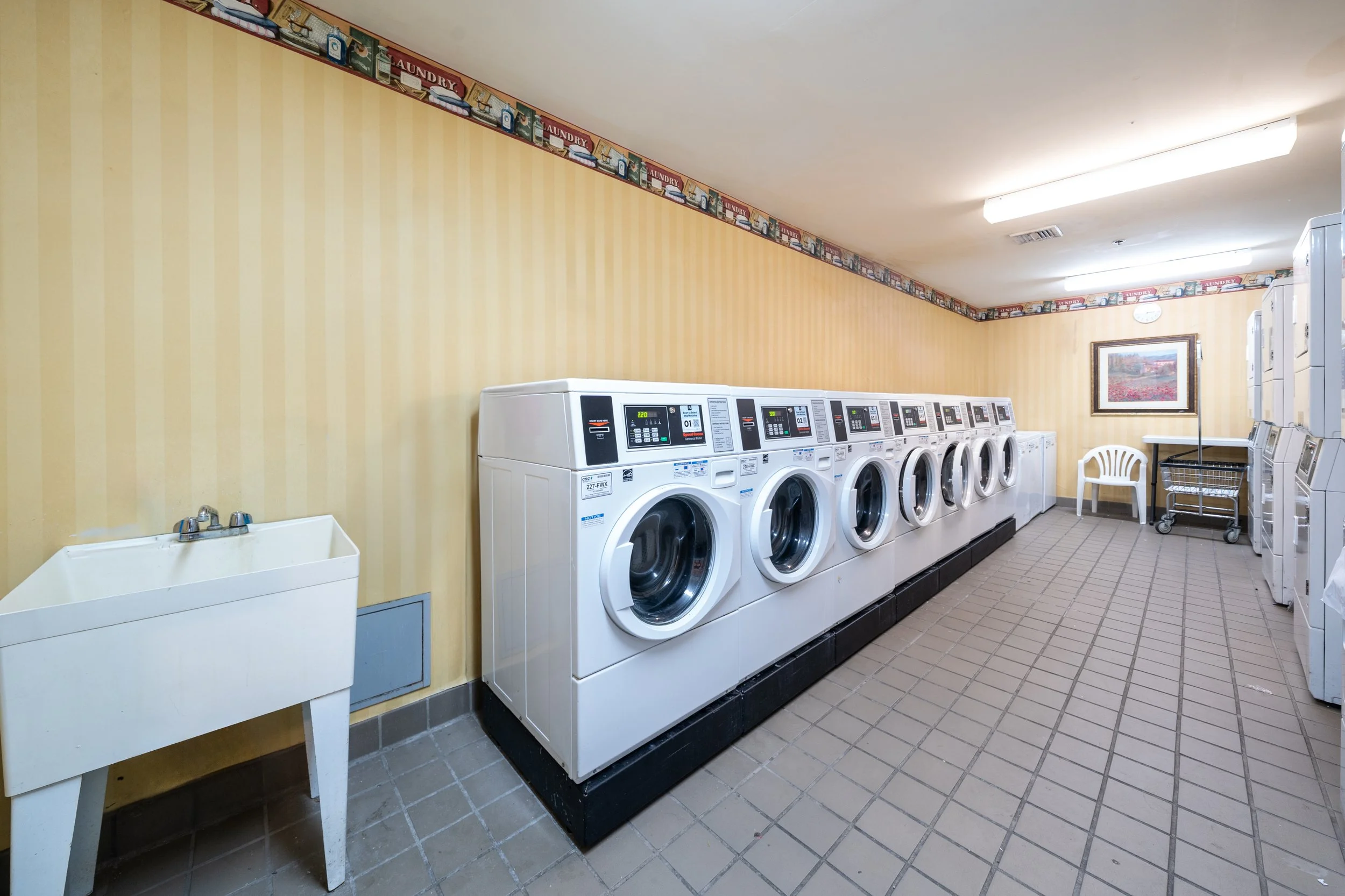 Laundry room with washing machines and a sink