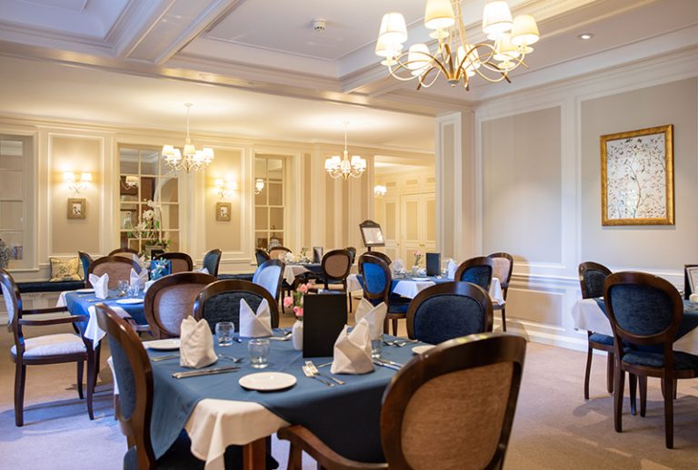 Elegant dining room with neatly set tables.