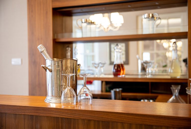 Bar area with wine glasses and a bottle.