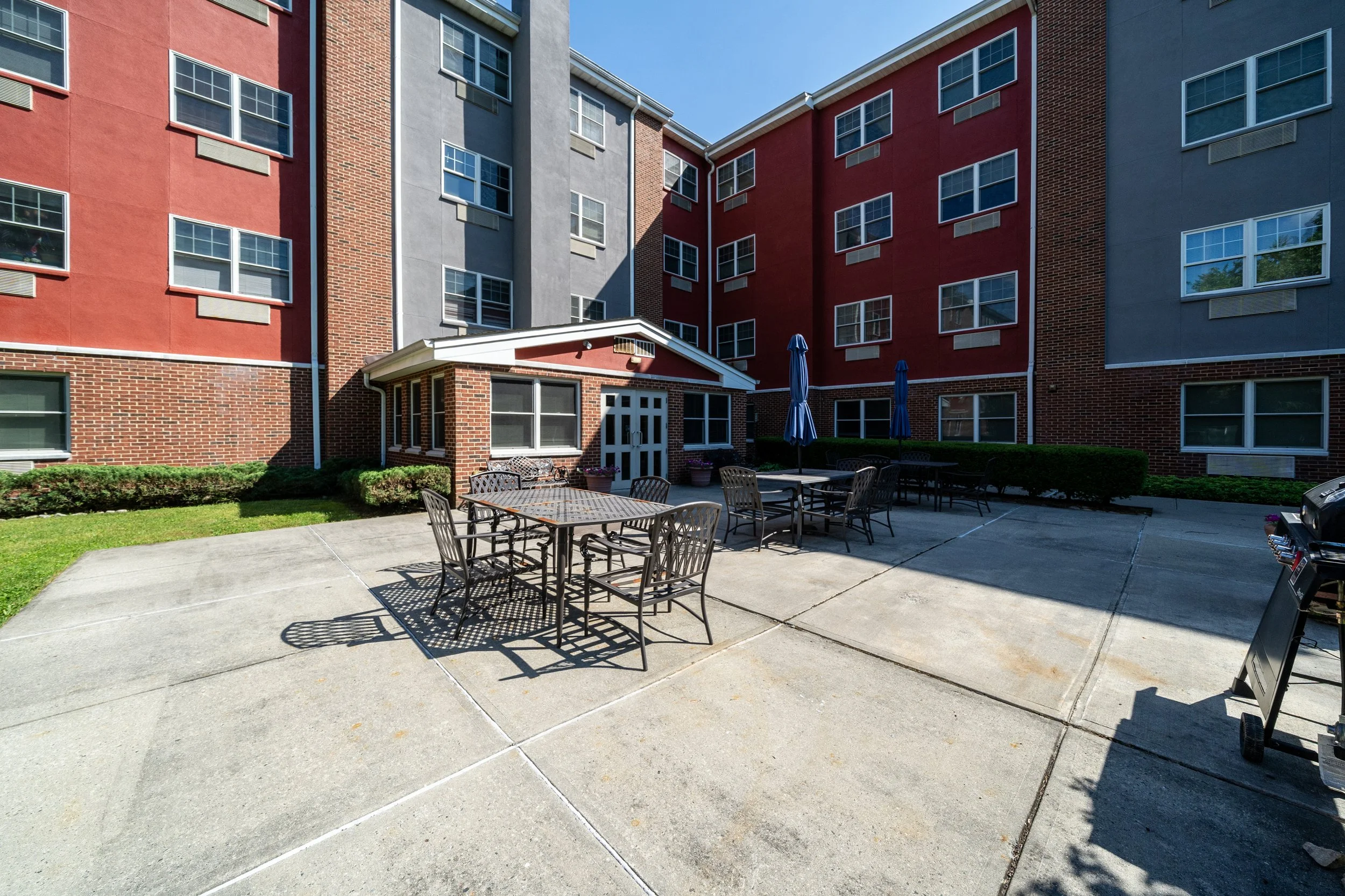 Outdoor patio area with seating and umbrellas.