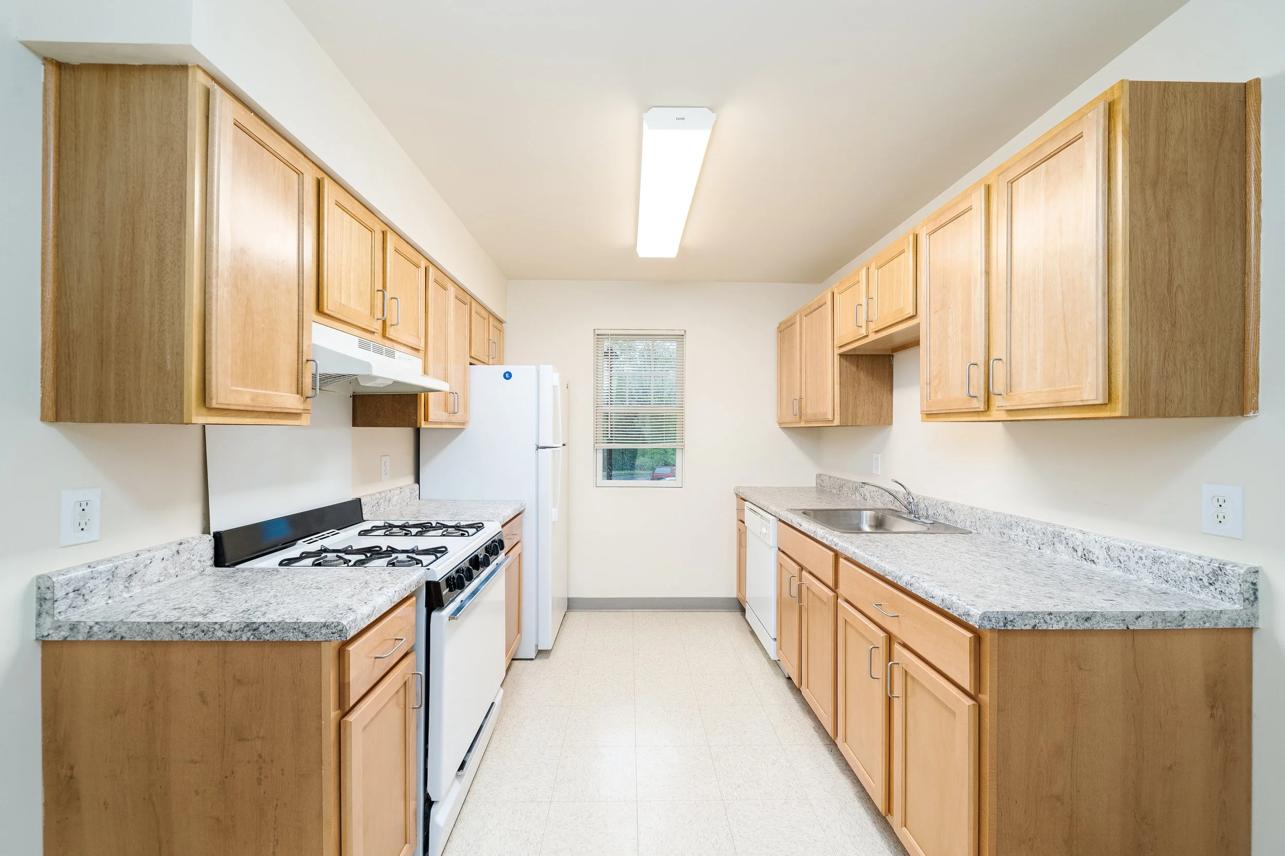 Bright kitchen area with wooden cabinets