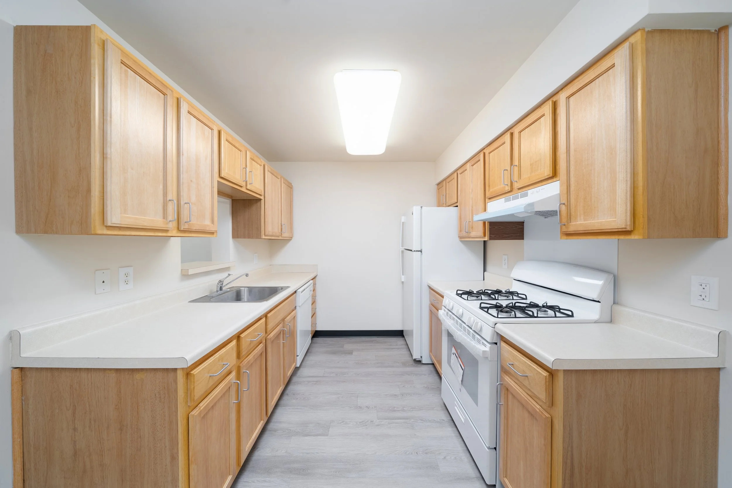 Bright kitchen with wooden cabinets and appliances