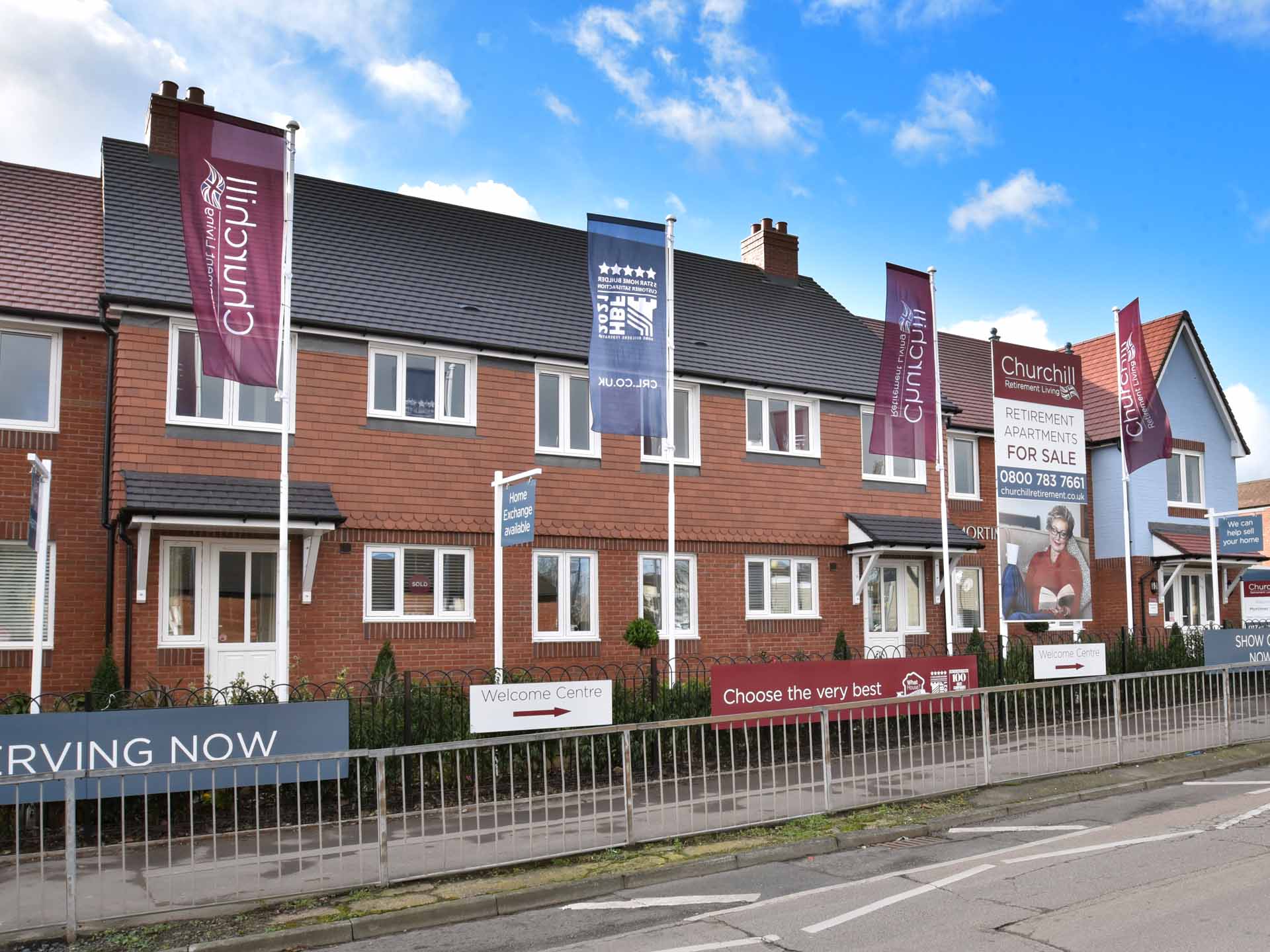 Exterior view of a senior living facility with banners