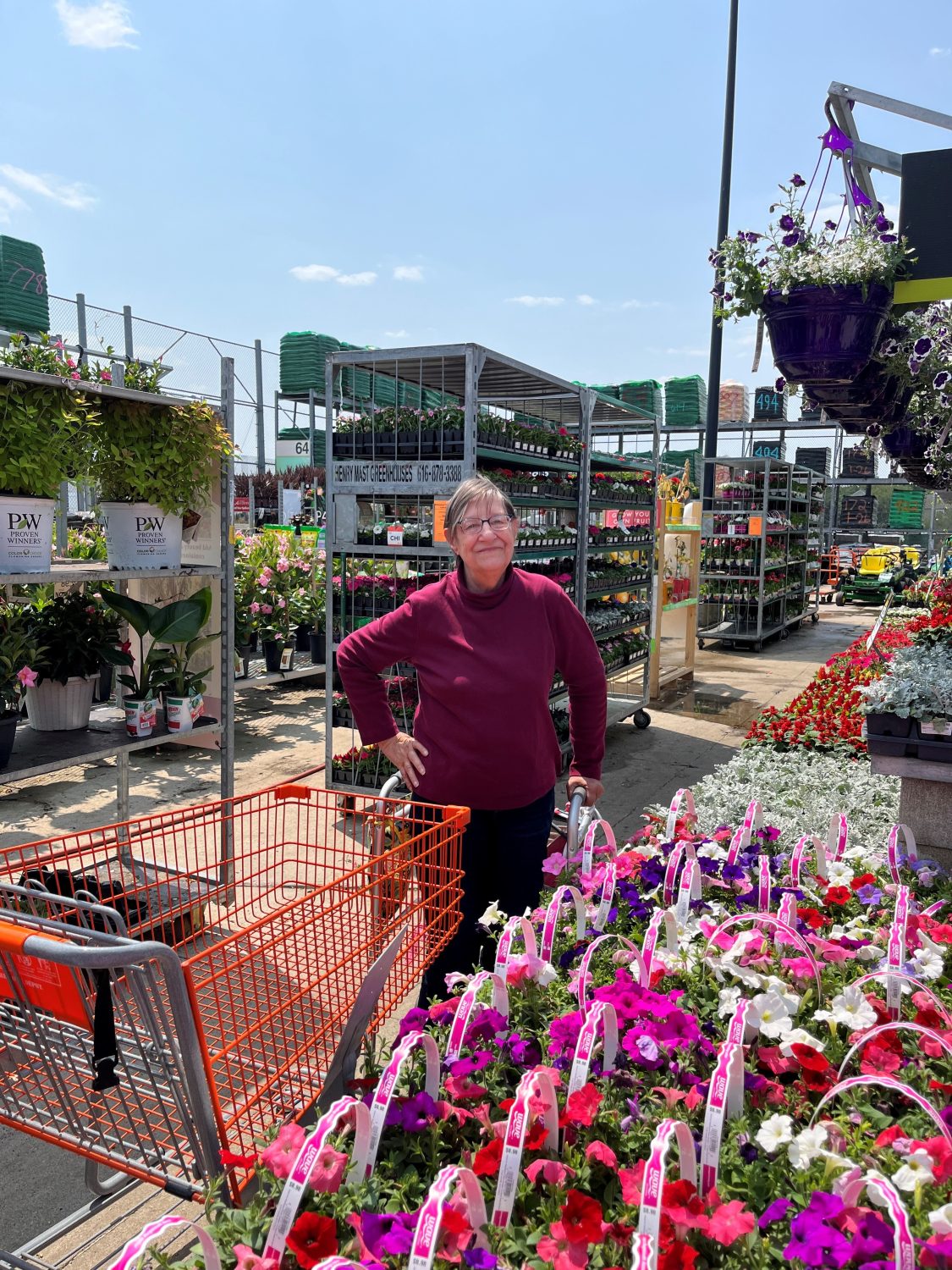 Resident at a flower market surrounded by blooms
