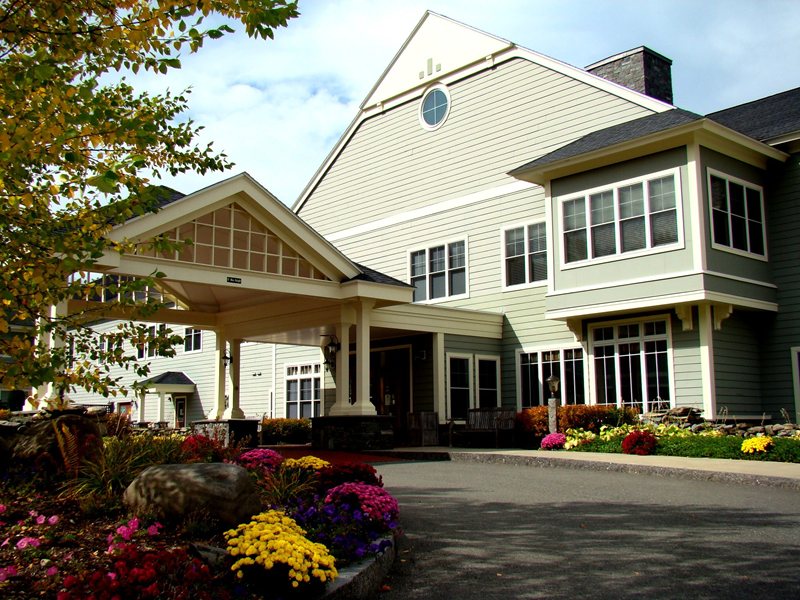 Exterior view of Dirigo Pines facility with landscaped entrance