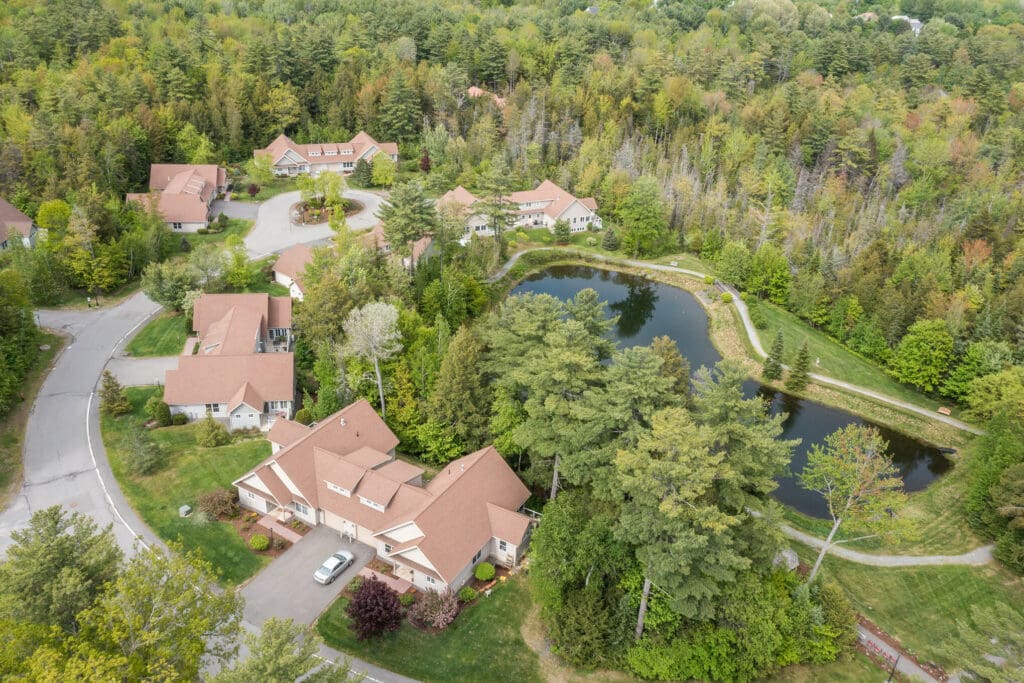 Aerial view of a senior living facility surrounded by greenery