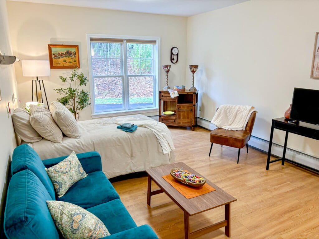 A well-furnished resident room with natural light