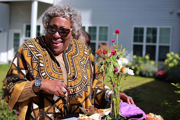 Resident enjoying an outdoor meal with flowers