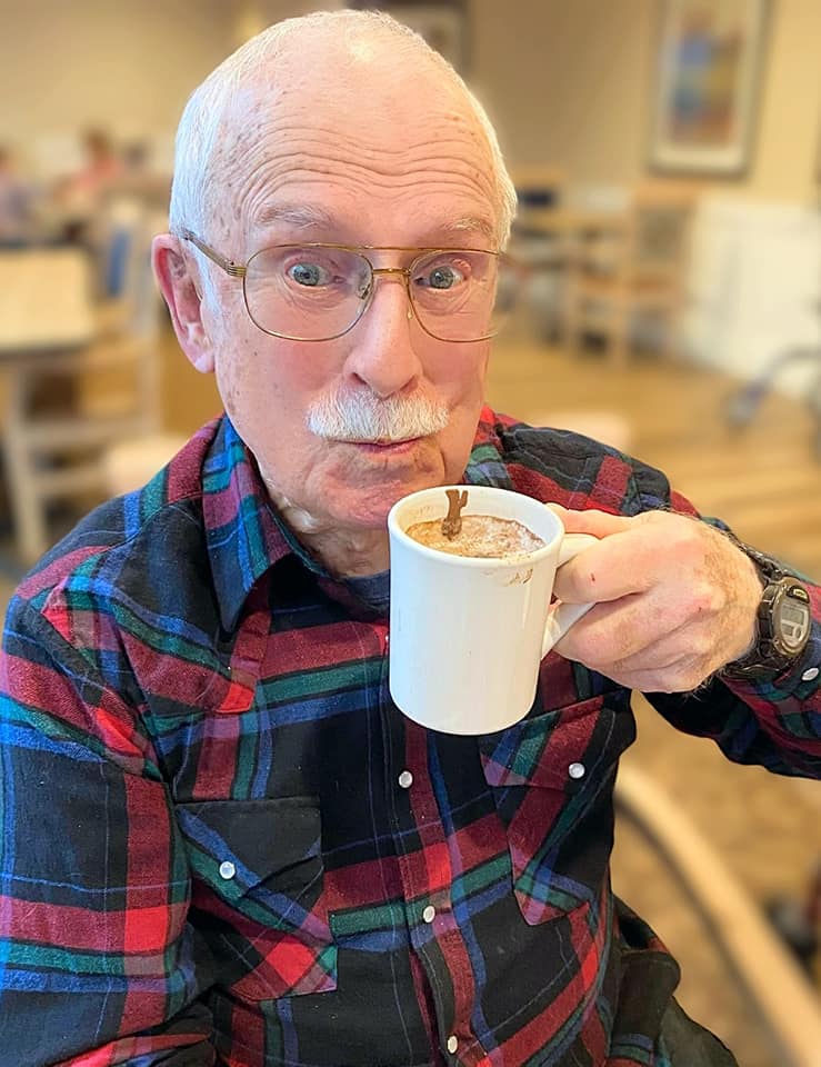 A happy resident enjoying a cup of coffee
