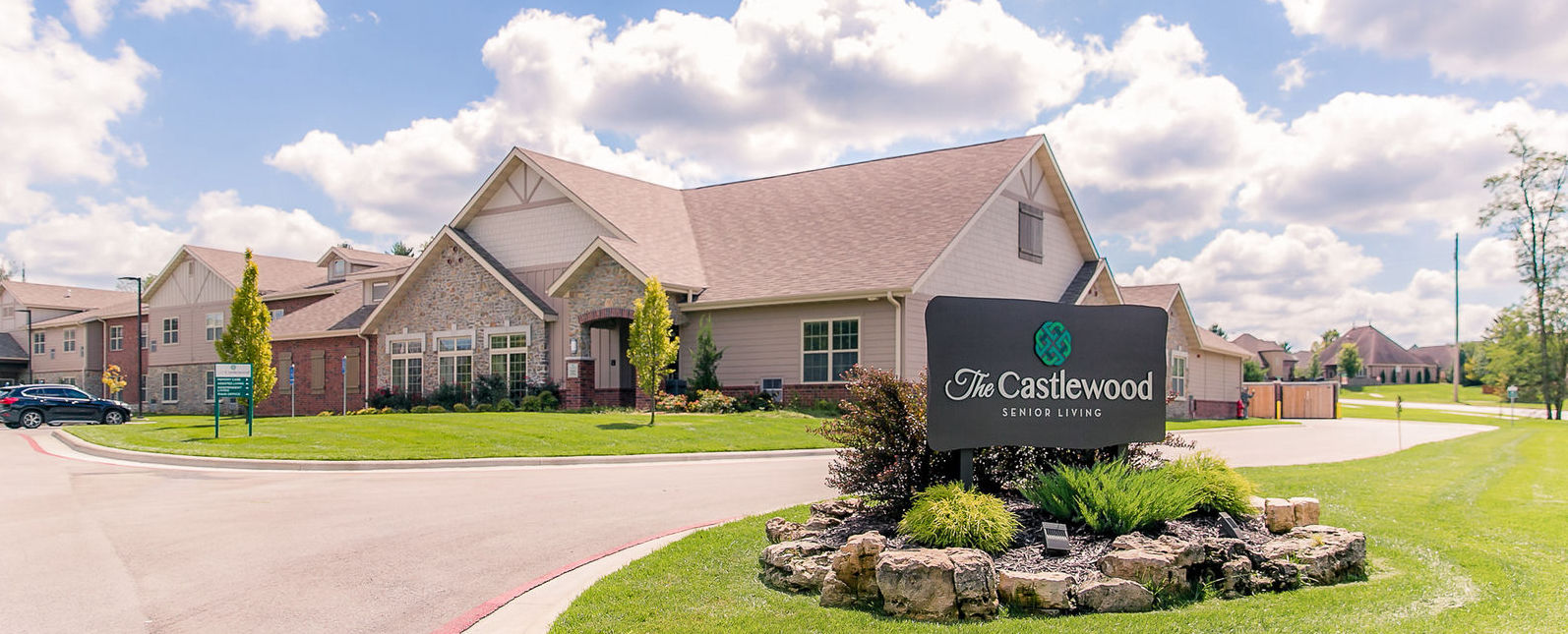 Exterior view of The Castlewood Senior Living with signage