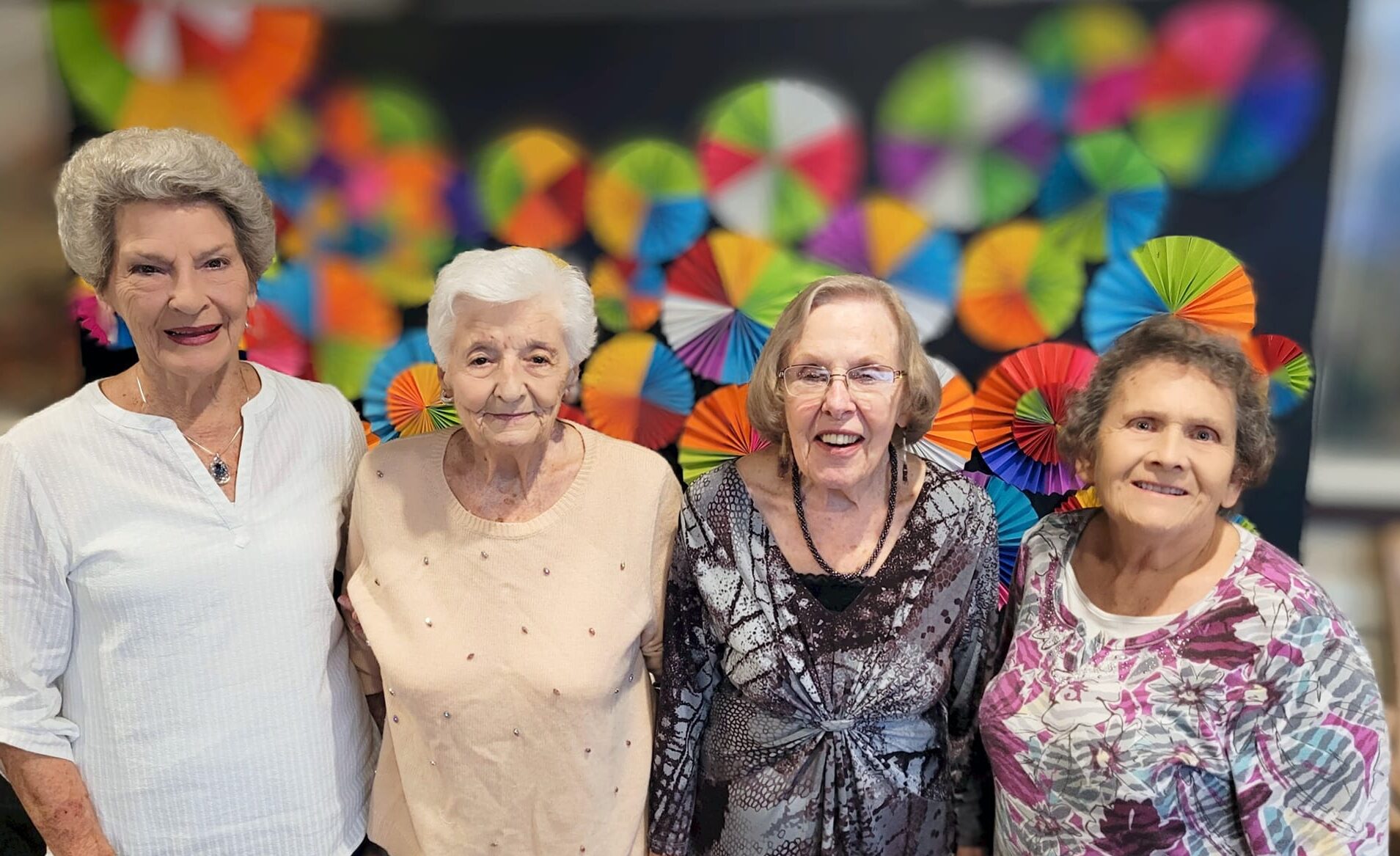 Residents smiling and posing together in a decorated space
