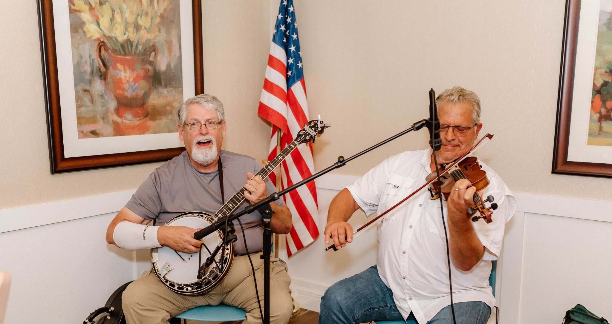 Musicians performing in a common area with an American flag