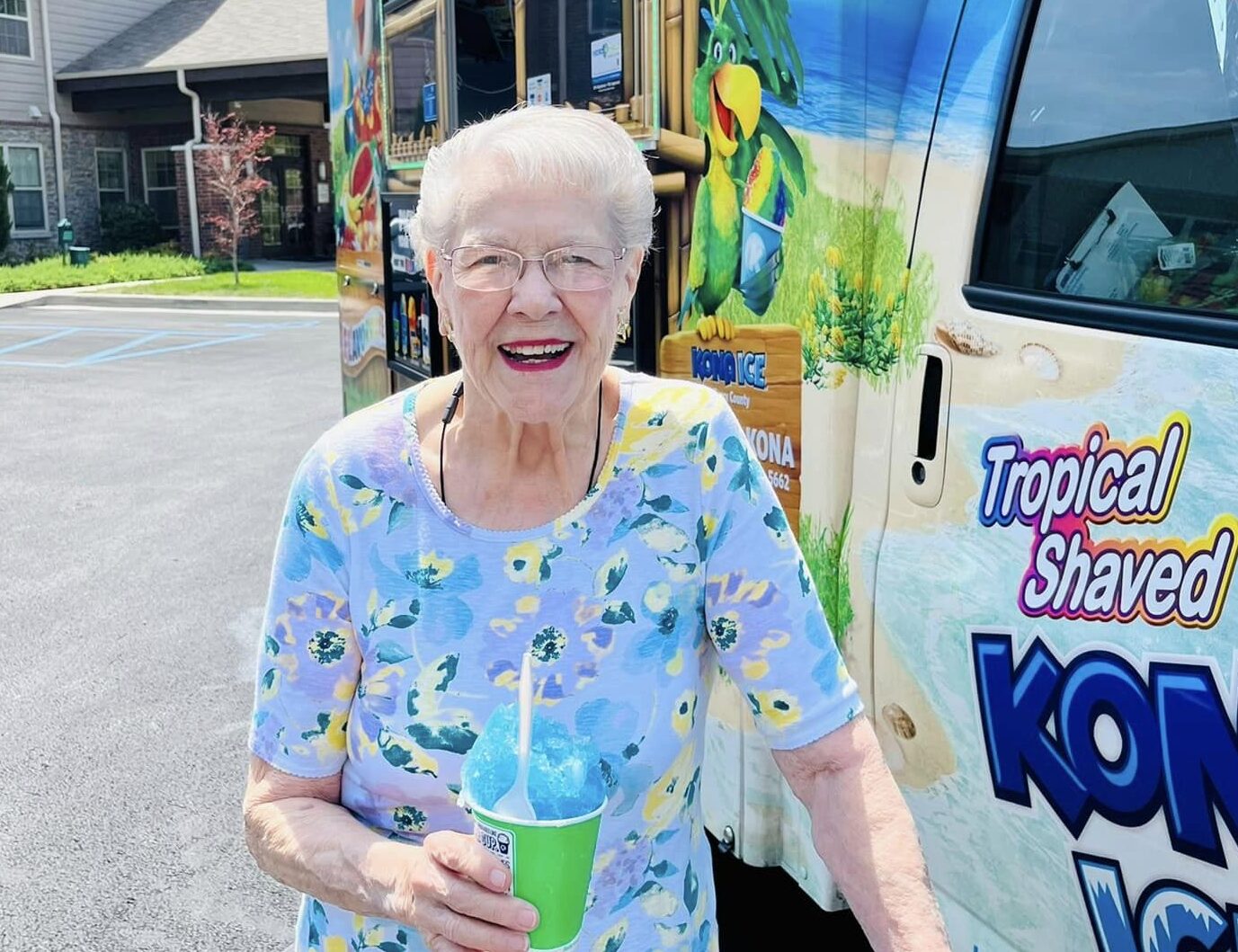 Resident enjoying a snow cone outside near the facility