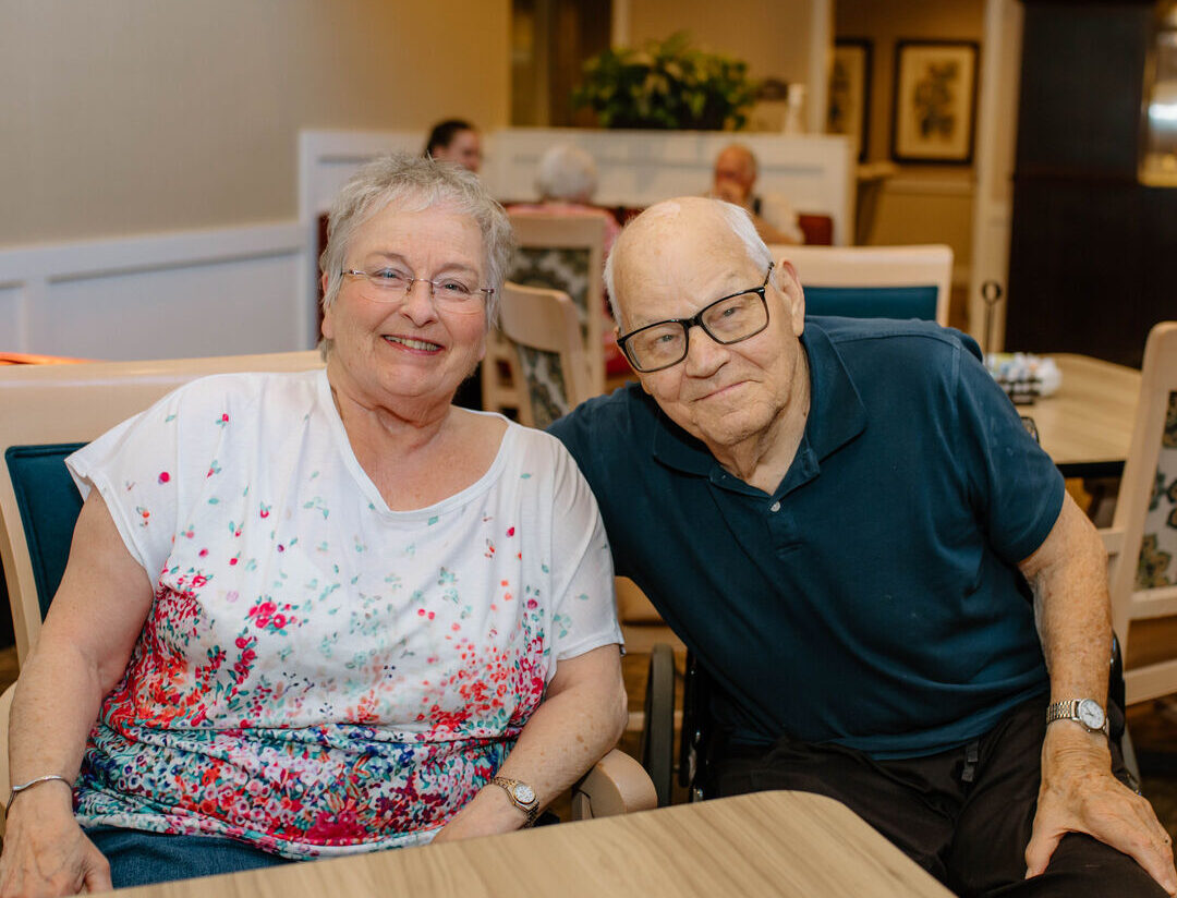 Two residents smiling in a common area