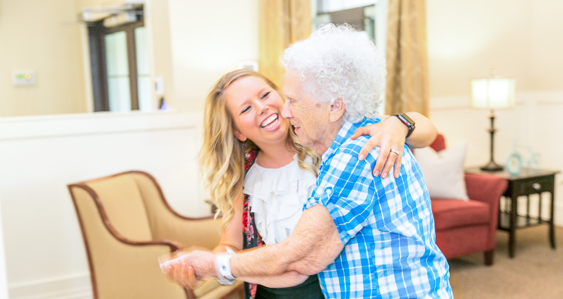 A staff member and resident enjoying a dance together