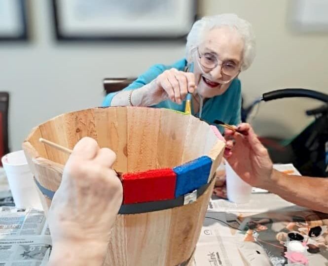 Residents engaged in a craft activity with paint