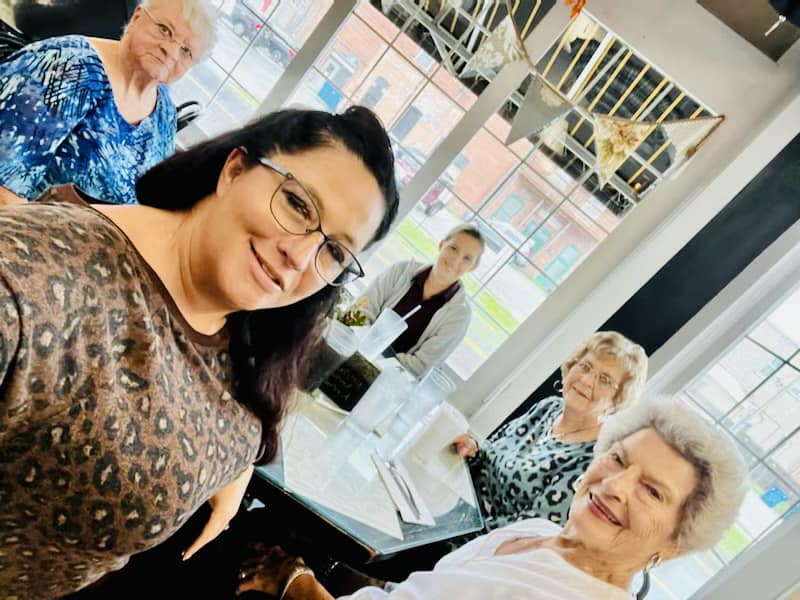 Residents and staff smiling in a common area