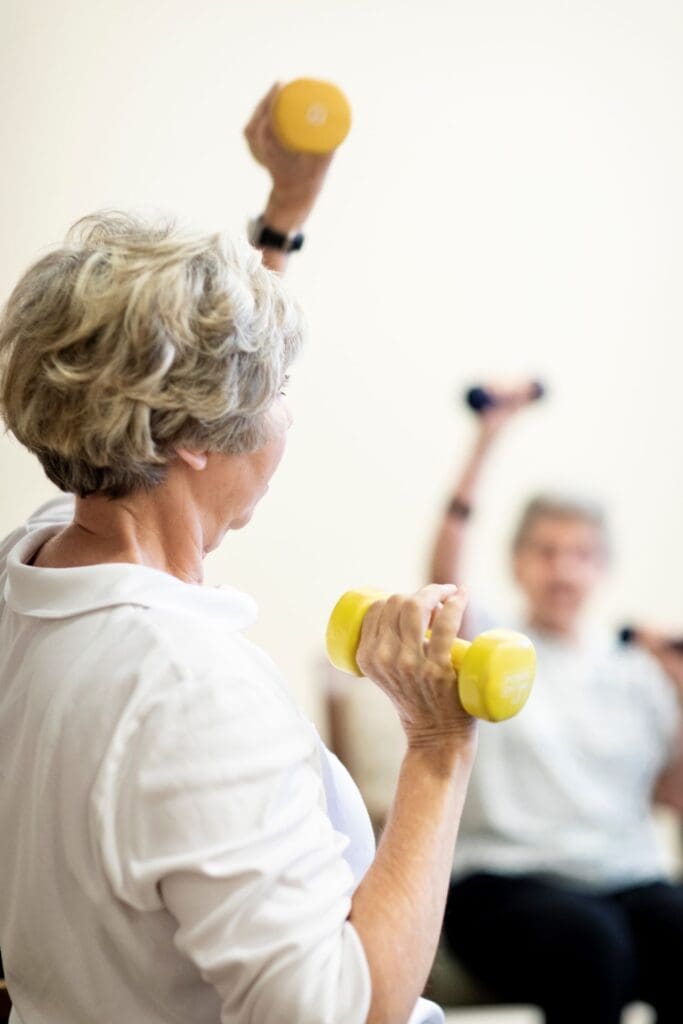 Residents participating in a fitness activity with dumbbells