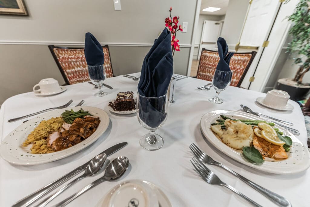 Dining table set with meals and drinks.