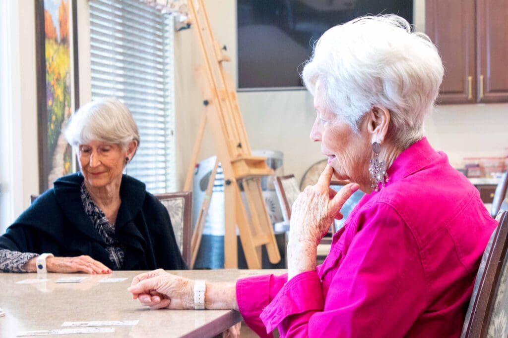 Residents engaged in a card game at a common area