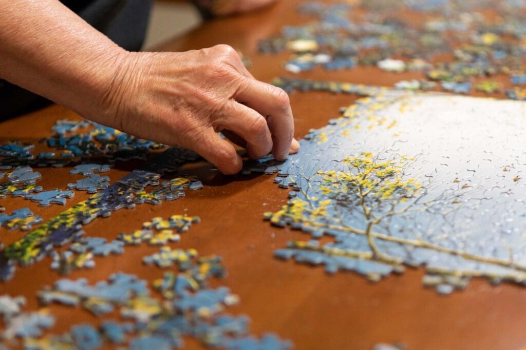 A resident working on a jigsaw puzzle at a table