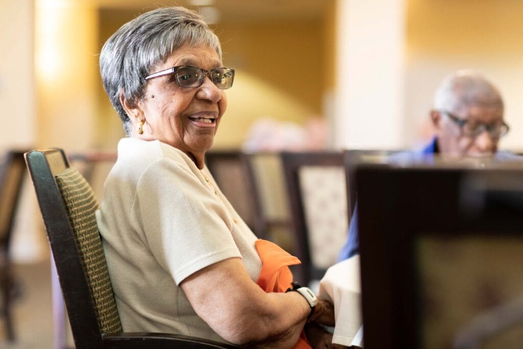 Resident smiling in a common area of the facility