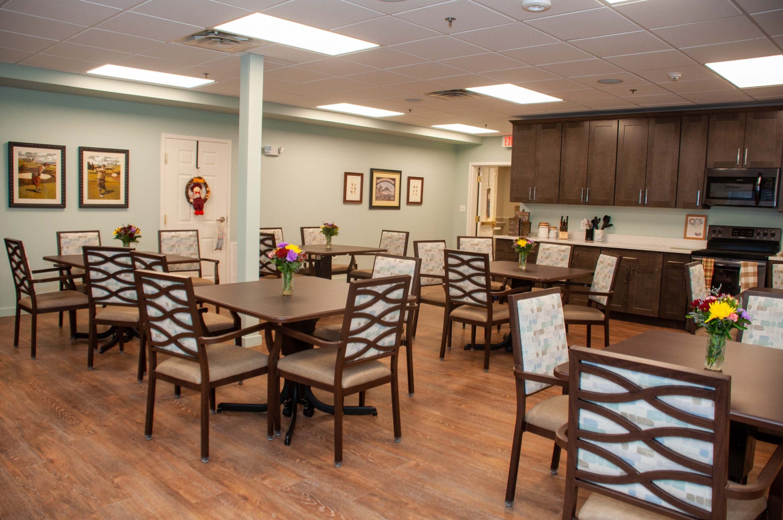 Dining area with tables and chairs arranged.