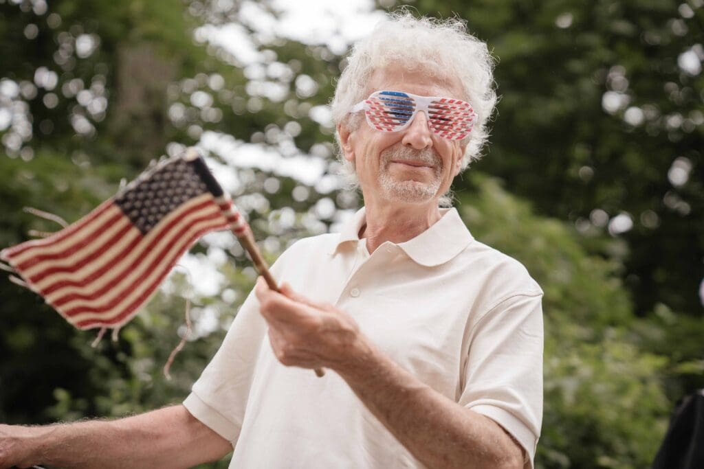 Resident celebrating with flag and patriotic sunglasses