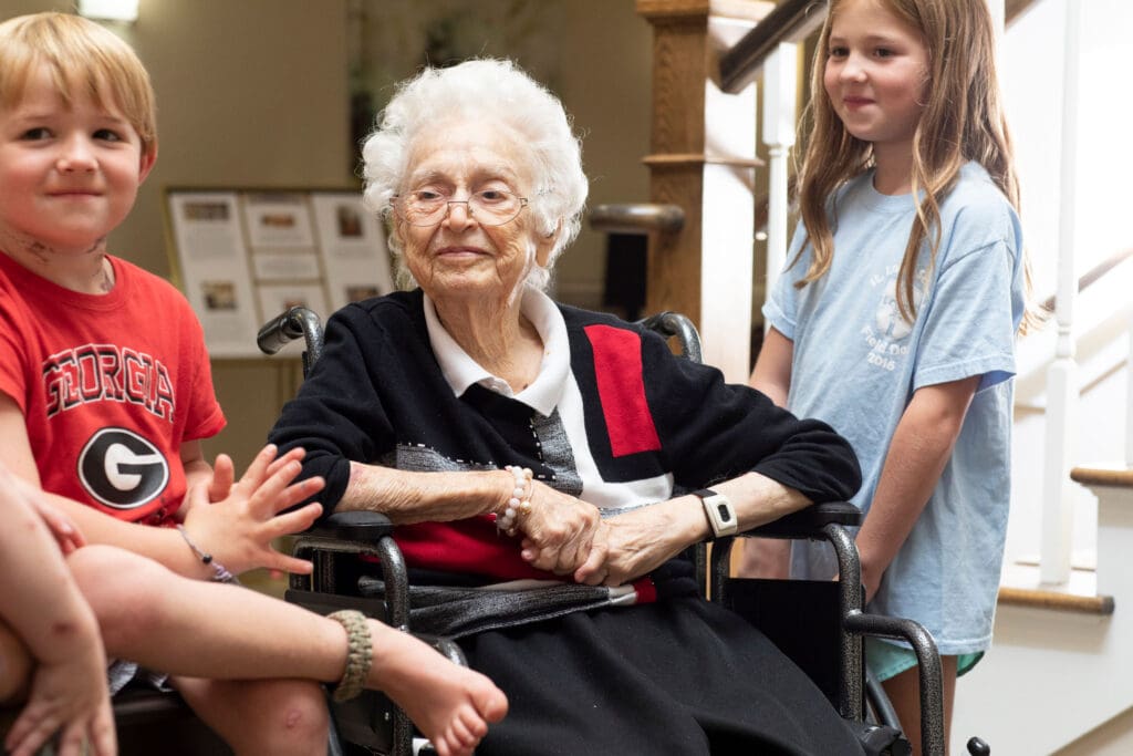 Residents interacting with children in a common area