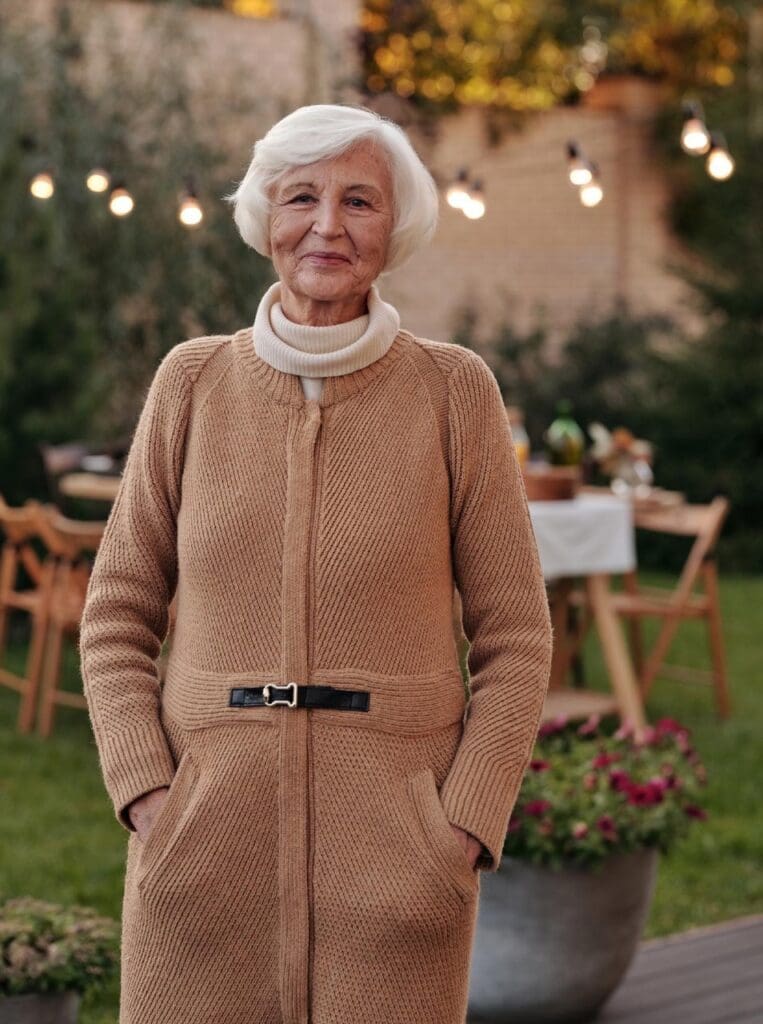 A senior woman smiling in a garden setting