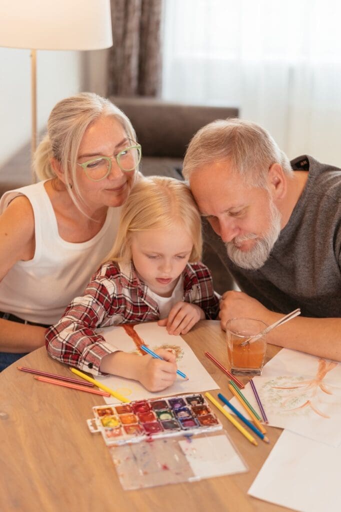 Residents and a child engaged in an art activity