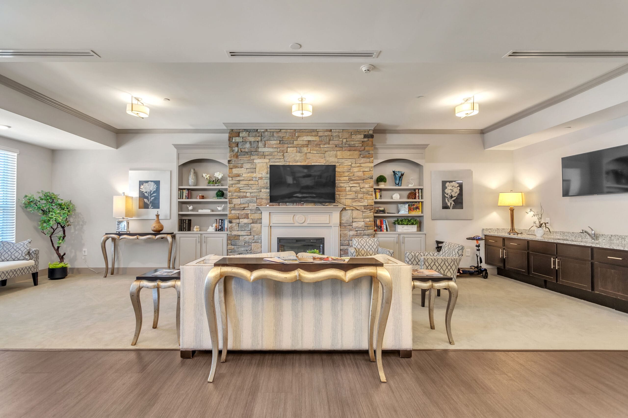 Bright common area with seating and a fireplace