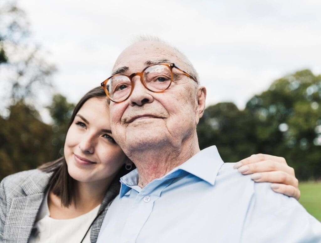 A resident and caregiver enjoying time outdoors