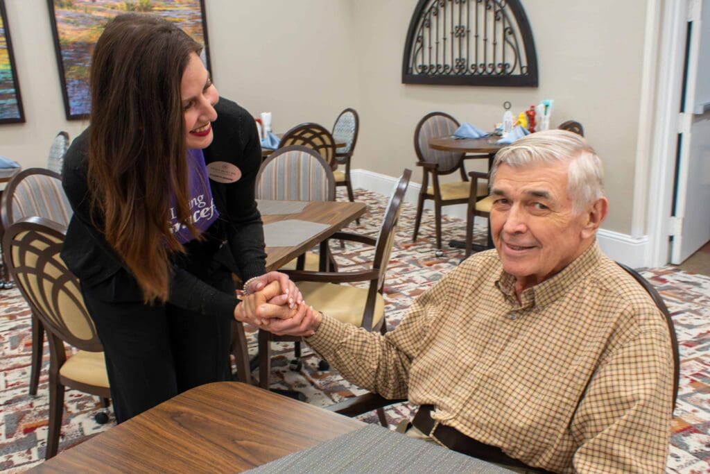 Staff member interacting with a resident in the dining area