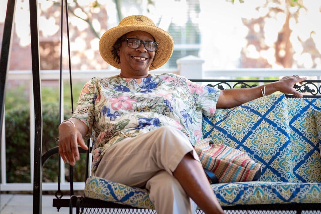 Resident relaxing on a swing in a common area