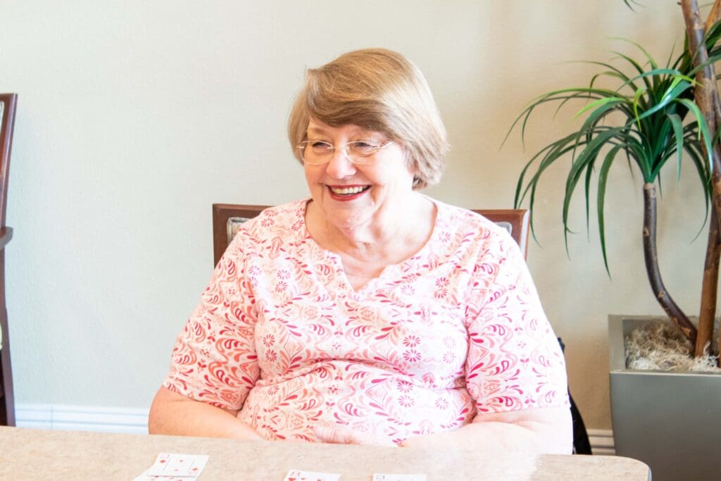 Resident enjoying a game at a table