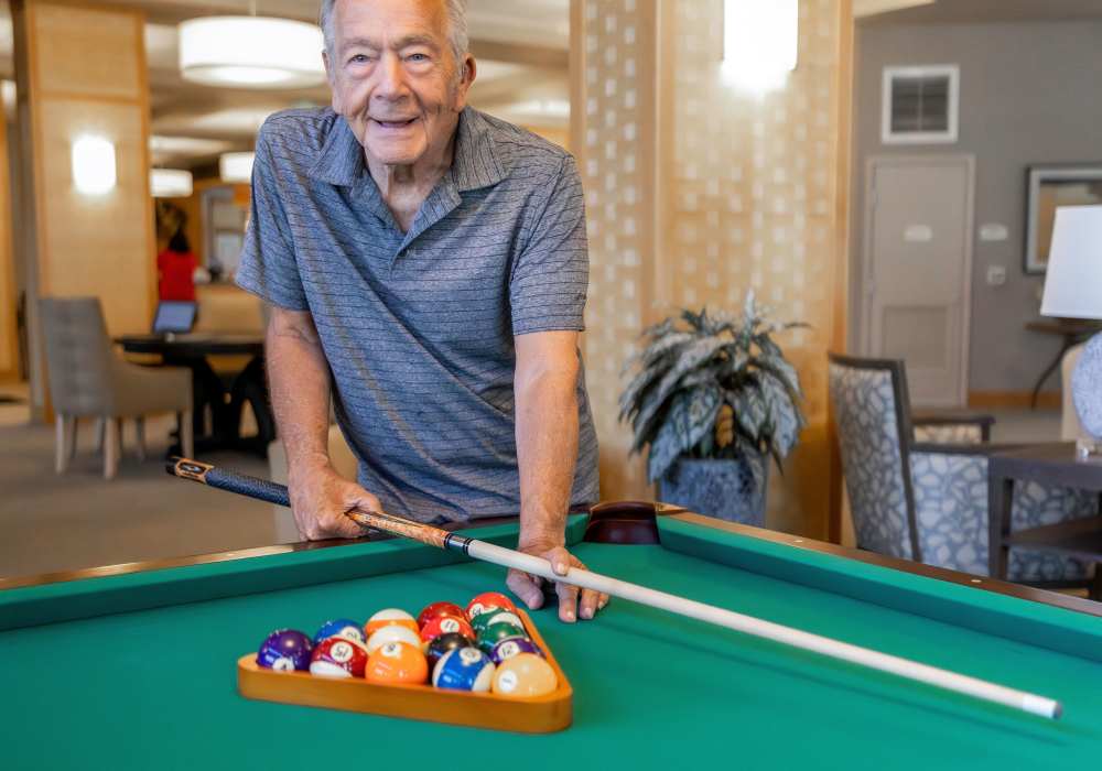 Resident playing pool in a common area