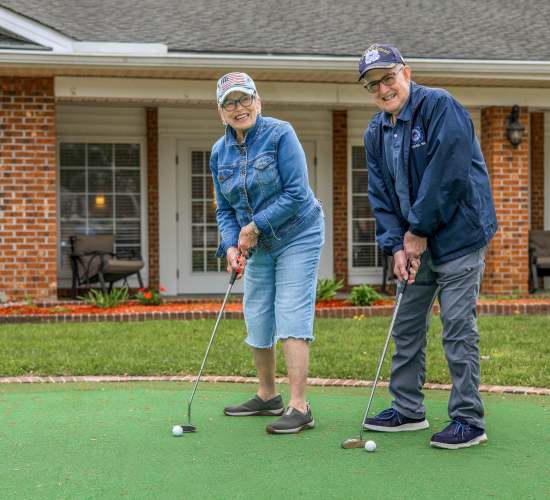 Residents enjoying putting on a green outdoor space