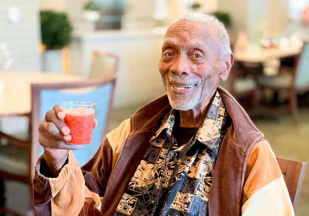 Resident enjoying a drink in a common area
