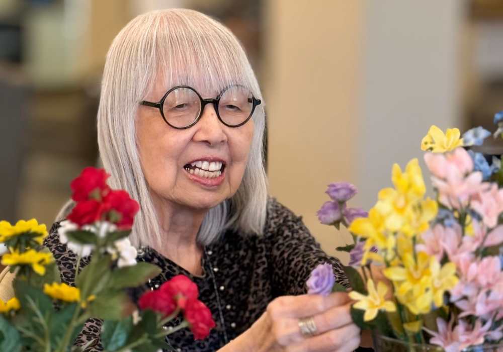 Resident arranging flowers in a common area