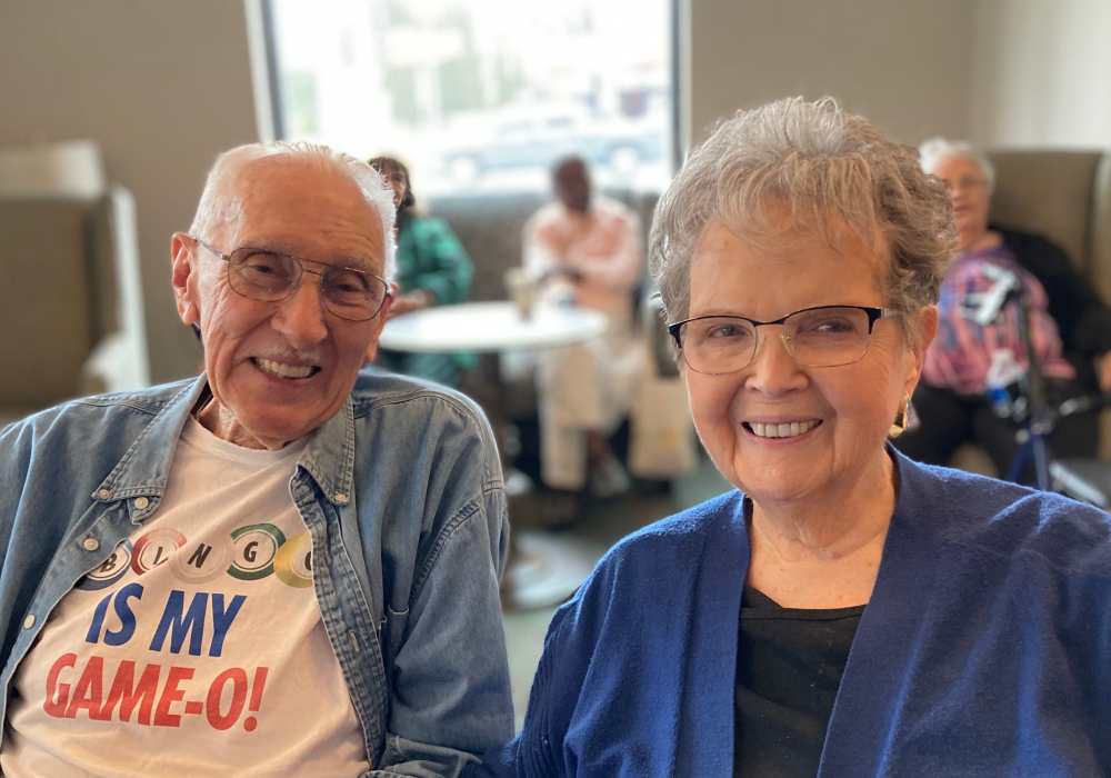 Two residents smiling during an activity in a common area
