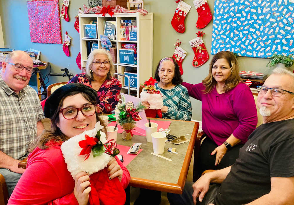 Residents and staff celebrating in a festive common area