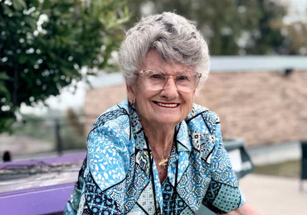 Senior resident smiling in an outdoor area