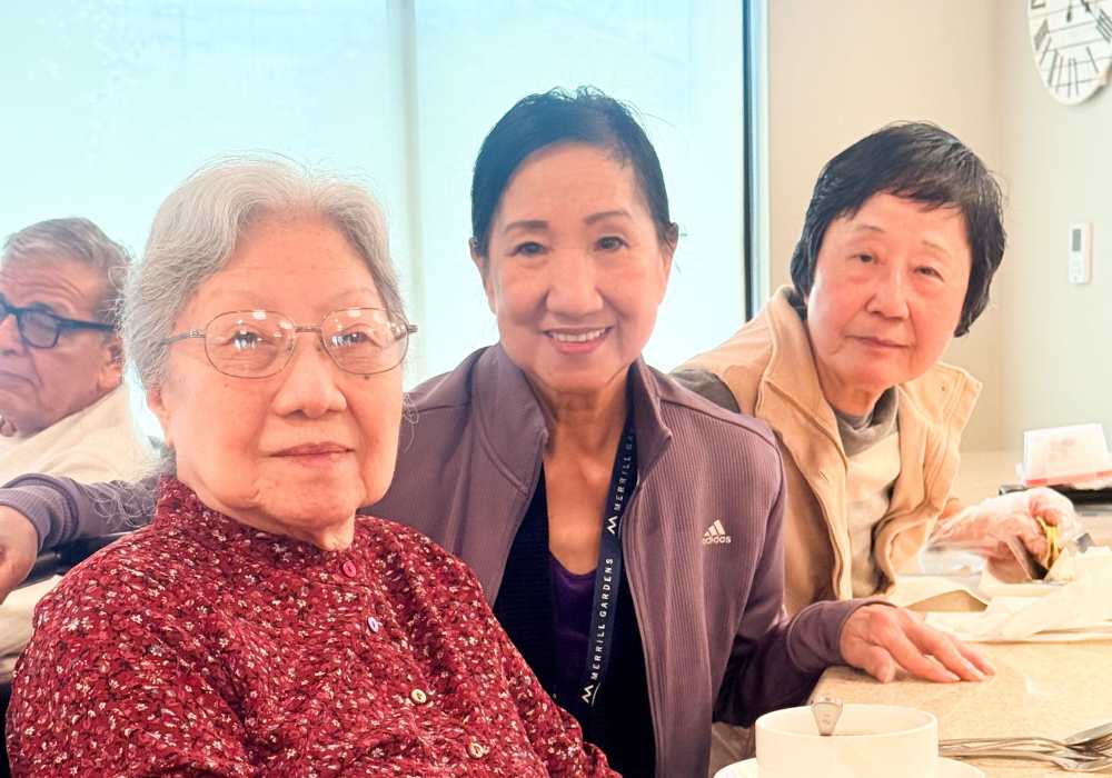 Three residents sharing a moment at a table