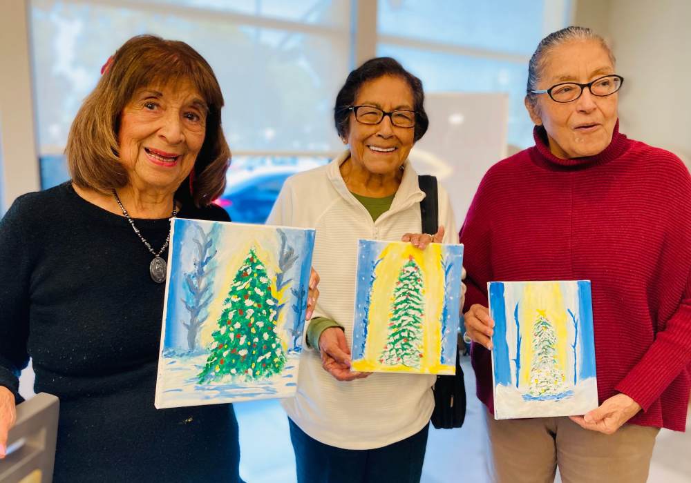Residents displaying their Christmas tree paintings